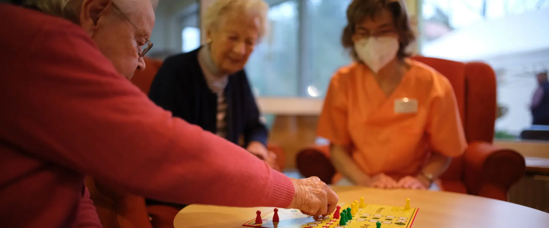 Spielenachmittag im Sankt Vitus: Zwei Bewohnerinnen und eine Fachkraft spielen gemeinsam