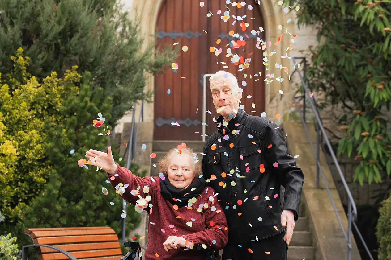 Alfred und Monika werfen Konfetti von der Kirche in Neuerkerode